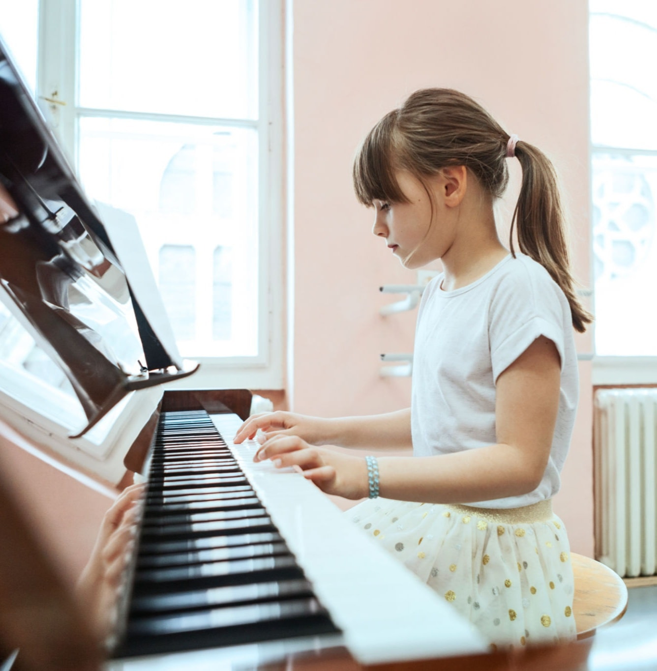 Child learning piano at home